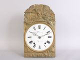 a gold clock with roman numerals on the face