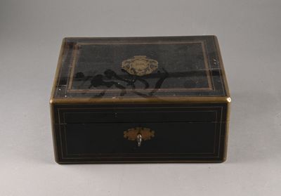 a small black box with a gold decoration on it