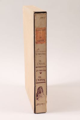 an old book sitting on top of a white table next to a white wall