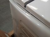 a white washing machine sitting on top of a wooden pallet
