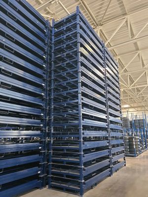 a large amount of pallets are stacked up in a warehouse