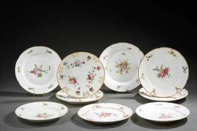several plates with floral designs are arranged on a table