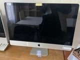 a computer monitor sitting on a desk next to a keyboard and mouse