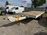 a flatbed trailer that is parked in a parking lot