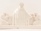 a white statue of a man and a woman sitting on a bench