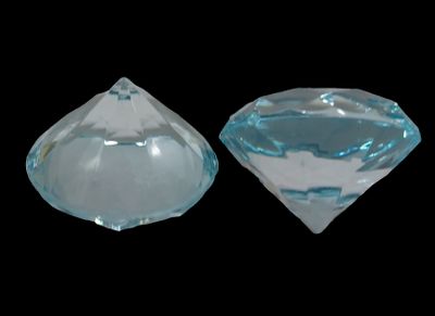 two pieces of clear glass sitting on top of a black surface