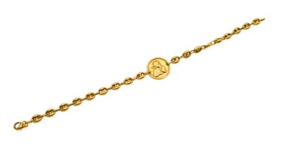 a gold chain bracelet with a coin on it
