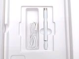 a white box with a pen and a charger inside of it