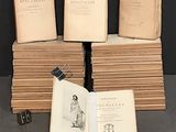 several old books are stacked on top of each other on a table