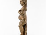 a wooden statue of a woman holding a baby