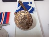 a medal and a medal on a white table