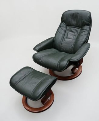 a black leather recliner chair and ottoman on a white background