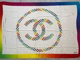 a white quilt with a chanel logo on it