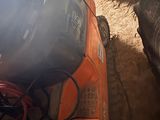 a car that is sitting in the dirt with a bunch of wires on it