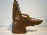 statue of a dog head on a table with a white background