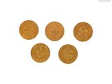 a close up of four gold coins on a white surface