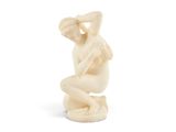 l'image d'une statue de femme assise sur un tabouret