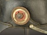 a close up of a helmet with a button on it