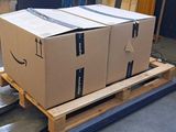 boxes on a pallet in a warehouse are stacked on top of each other