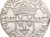 a close up of a coin with a crown on it