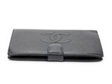 a chanel black leather wallet with a cc logo on the front