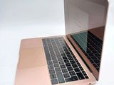 a close up of a laptop on a white surface