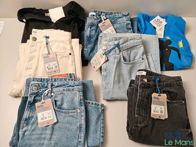 several pairs of jeans are laid out on a table