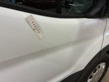 a white van with a sticker on the side of it ' s door