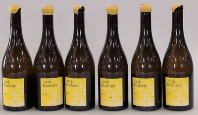 six bottles of wine are lined up in a row