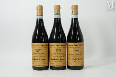 three bottles of wine sitting on top of a white table