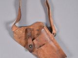 an old leather holster with a leather strap hanging from it ' s side