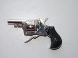 a silver revolver with a black handle on a white surface
