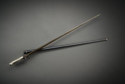 a metal stick with a long handle on a table