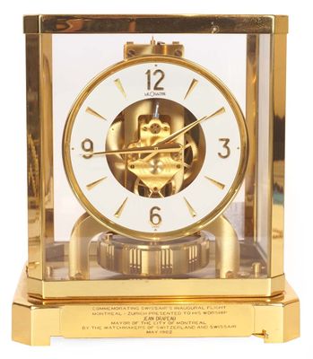 a gold clock that is sitting on top of a table