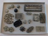 a picture of a tray with many different types of brooches