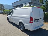 a white van that is parked on the side of the road