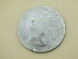 a silver coin with a picture of a lion on it