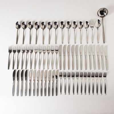 many forks and spoons laid out on a white surface