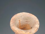 a small brown vase that is sitting on a table