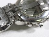 a close up of a watch on a white surface