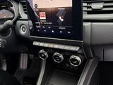 the interior of a car with a touch screen and a steering wheel