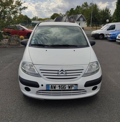la petite voiture blanche est garée dans le parking