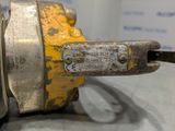 a close up of a metal object with yellow paint on it