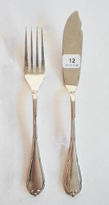 deux fourchettes et un couteau sur une table blanche