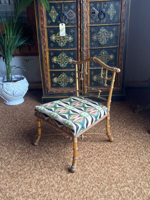 a chair that is sitting in front of a cabinet