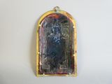 a small mirror hanging on the wall with a yellow frame
