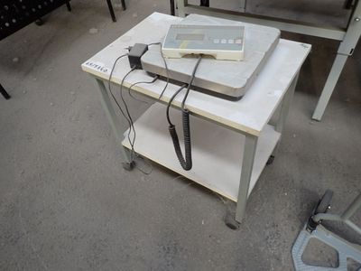 a table with a laptop and a phone on top of it