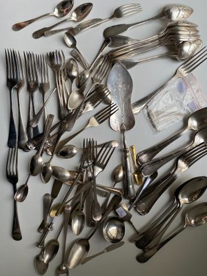 a lot of spoons and forks on the table