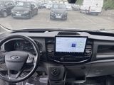 a dashboard view of a car with a lot of cars in the background
