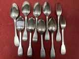 six spoons and a fork on a red cloth
